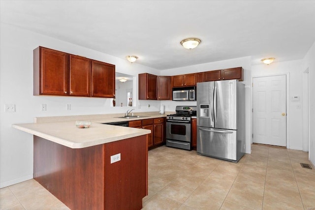 kitchen featuring sink, kitchen peninsula, light tile patterned floors, and stainless steel appliances