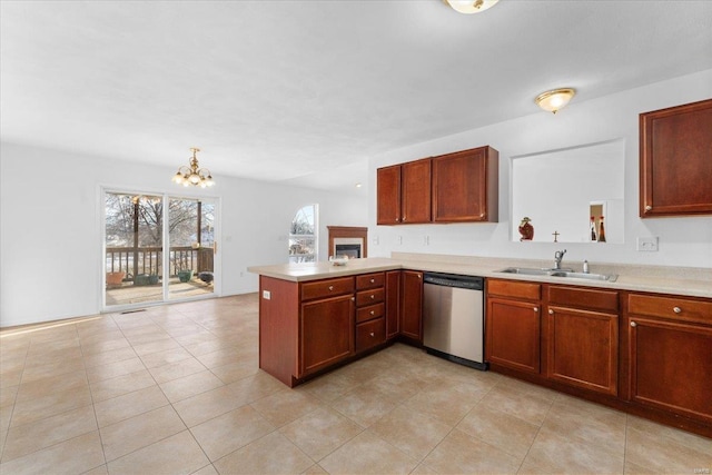 kitchen with a notable chandelier, dishwasher, light tile patterned floors, sink, and kitchen peninsula