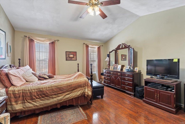 bedroom with dark wood-type flooring, vaulted ceiling, and ceiling fan