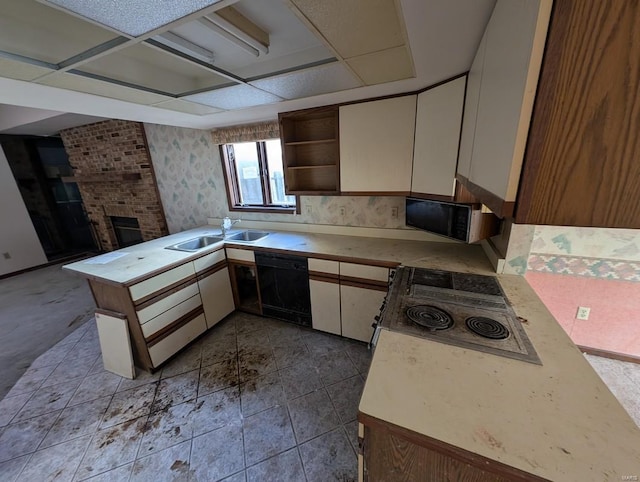 kitchen featuring dishwasher, kitchen peninsula, sink, white cabinetry, and stovetop