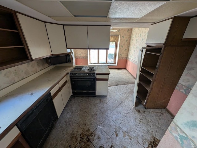 kitchen with stove, a drop ceiling, dishwasher, and white cabinetry