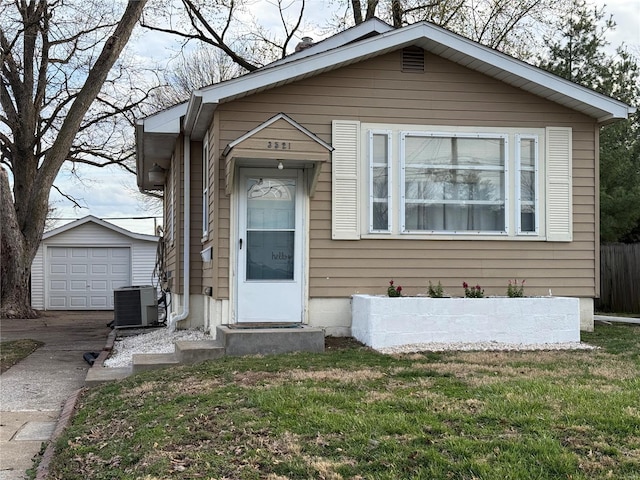 view of front of home with an outdoor structure, concrete driveway, central air condition unit, entry steps, and a front lawn