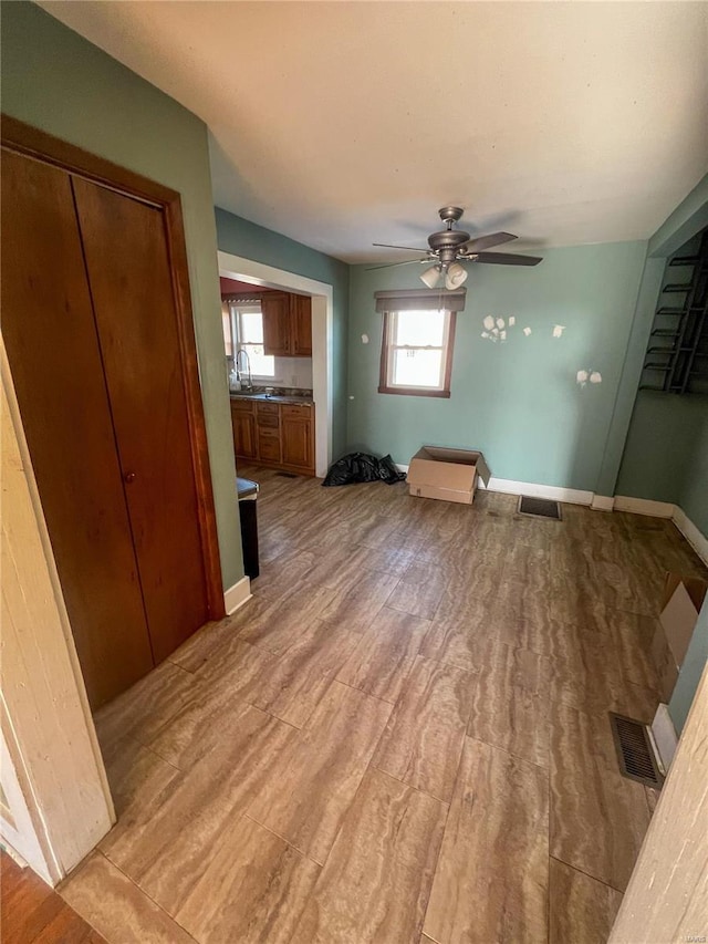 unfurnished dining area with ceiling fan and sink