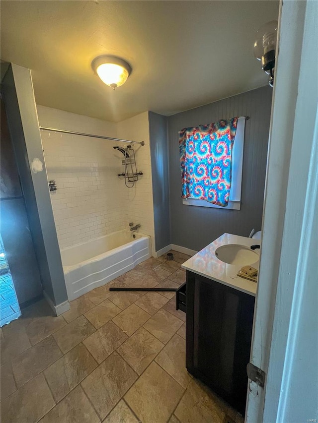 bathroom featuring vanity and tiled shower / bath