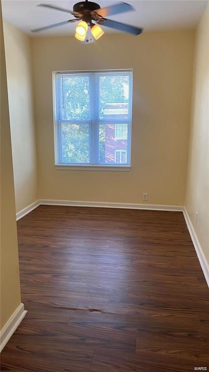 unfurnished room featuring ceiling fan and dark wood-type flooring