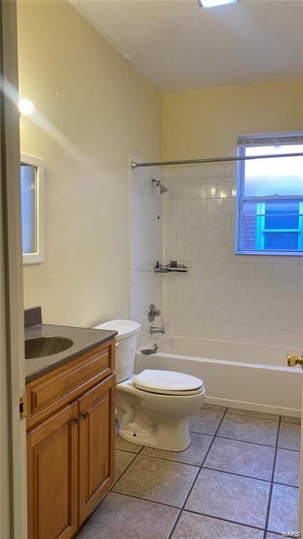 full bathroom with toilet, tile patterned flooring, tiled shower / bath combo, and vanity