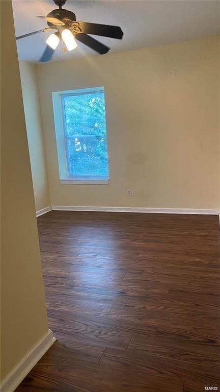 spare room with ceiling fan and dark wood-type flooring