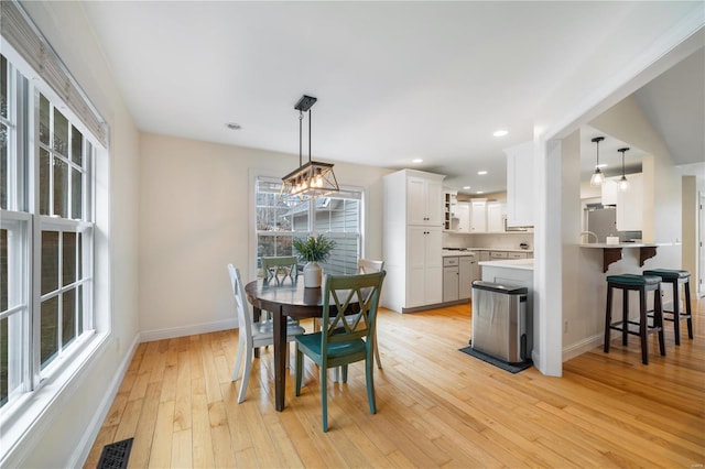 dining space with light hardwood / wood-style floors