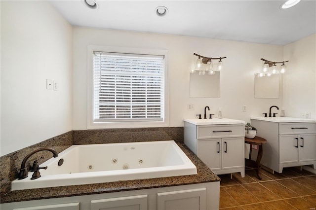 bathroom with tile patterned flooring, vanity, and a tub to relax in