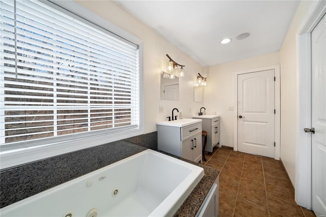 bathroom featuring vanity, a tub, and tile patterned floors