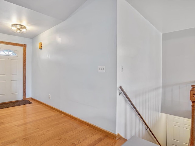 entryway with light wood finished floors and baseboards