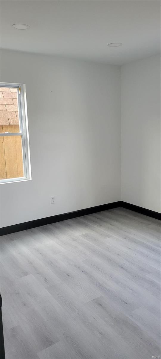 spare room featuring light wood-type flooring