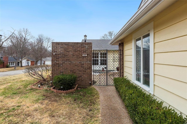 view of side of property with a gate