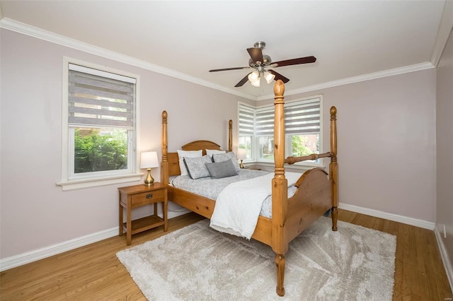 bedroom with multiple windows, crown molding, hardwood / wood-style floors, and ceiling fan