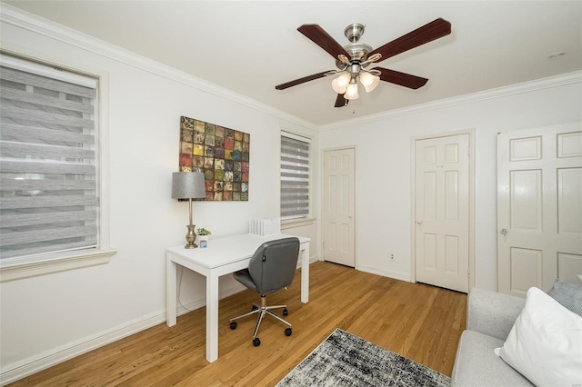 home office with crown molding, ceiling fan, and light hardwood / wood-style floors