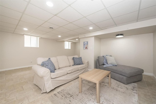 living room with a paneled ceiling