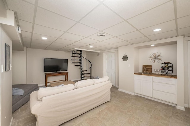 living room featuring a drop ceiling