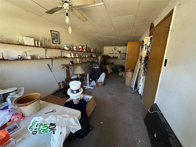 misc room with ceiling fan and concrete flooring