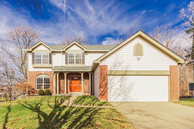 view of front of home featuring a garage and a front lawn