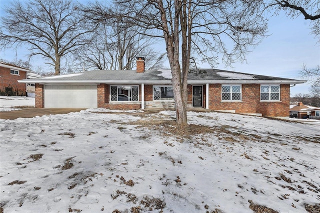 snow covered house with a garage