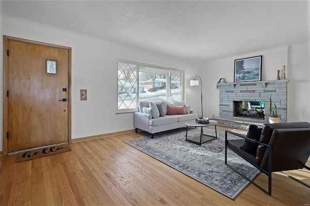 living room featuring a fireplace and light wood-type flooring