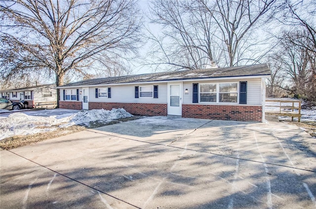 single story home featuring brick siding