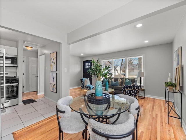 dining area with light wood-style flooring, baseboards, and recessed lighting