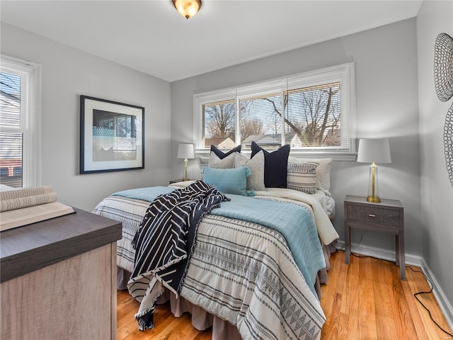 bedroom featuring light wood-style flooring and baseboards