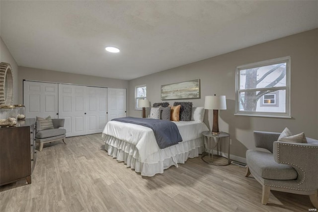 bedroom with a closet and light hardwood / wood-style floors