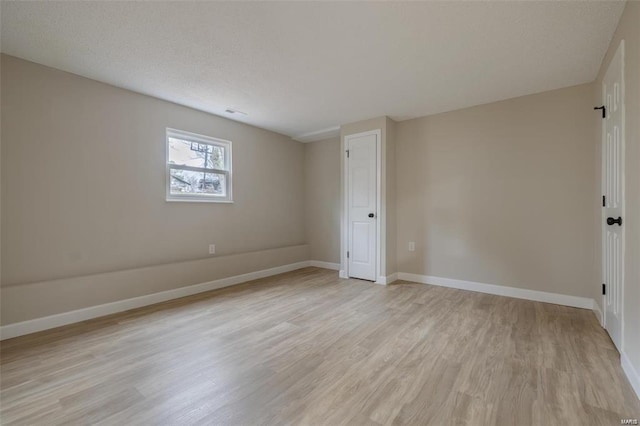 unfurnished room with light hardwood / wood-style flooring