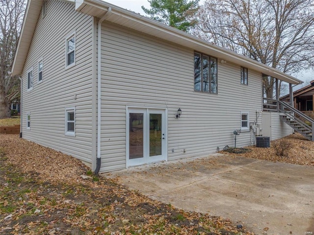 rear view of property featuring a patio area and central AC