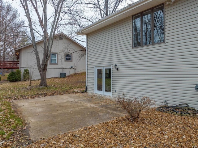 rear view of house featuring central AC and a patio