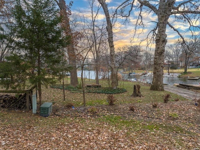 yard at dusk with a water view