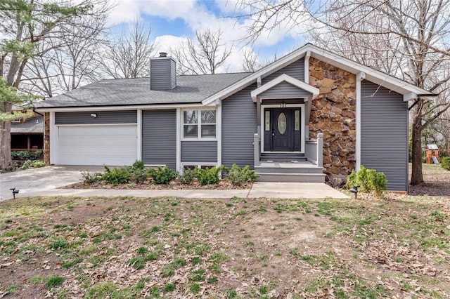 mid-century modern home featuring driveway, a chimney, and an attached garage