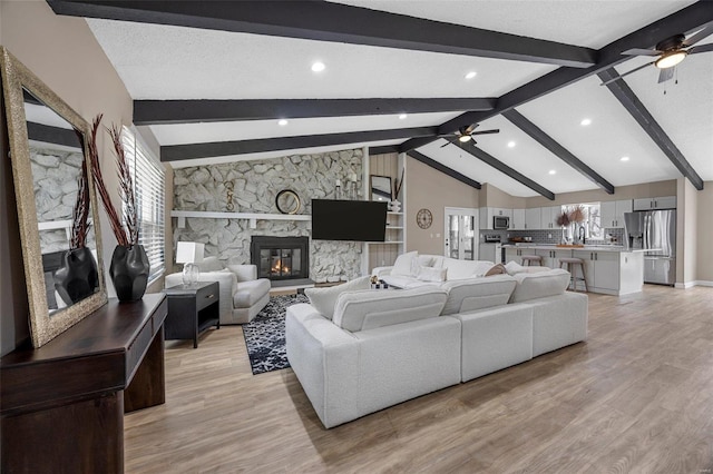 living area featuring light wood-type flooring, a healthy amount of sunlight, and ceiling fan