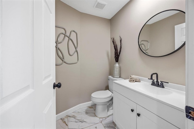 half bathroom featuring visible vents, toilet, marble finish floor, baseboards, and vanity