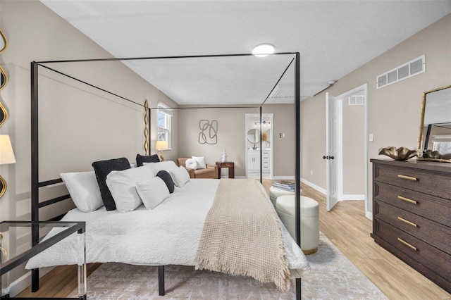 bedroom featuring visible vents, baseboards, and light wood-style flooring