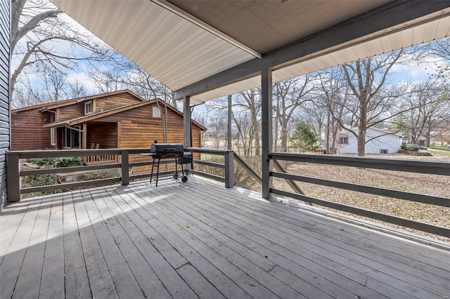 wooden terrace featuring a grill