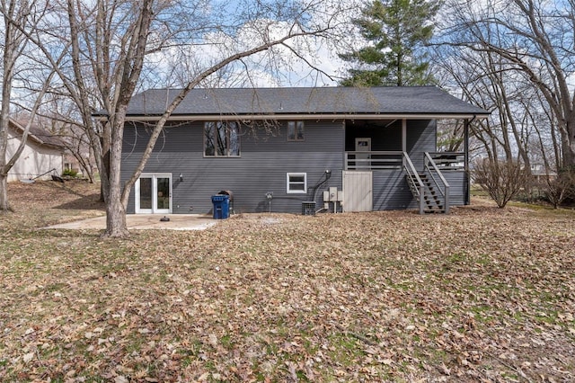 back of property with a patio area and stairs