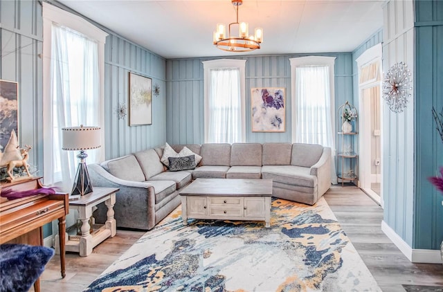 living room with light hardwood / wood-style flooring and an inviting chandelier