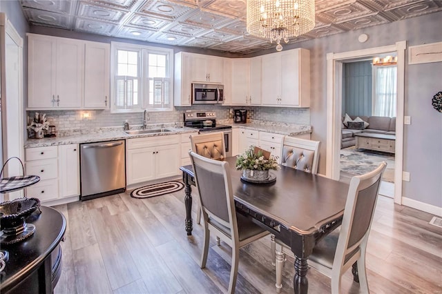 kitchen with sink, white cabinets, and stainless steel appliances