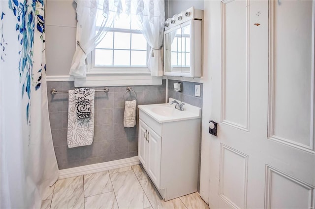 bathroom with vanity and tile walls