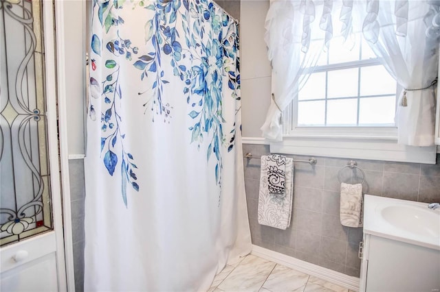 bathroom featuring tile walls, vanity, and a shower with curtain