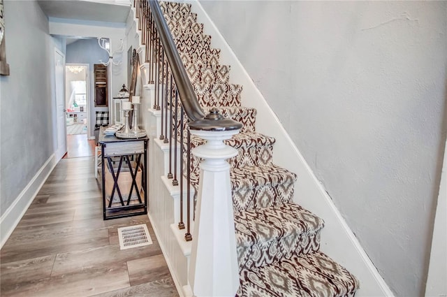 stairs with hardwood / wood-style floors