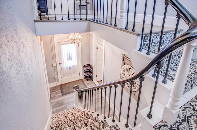 foyer featuring hardwood / wood-style flooring and a notable chandelier