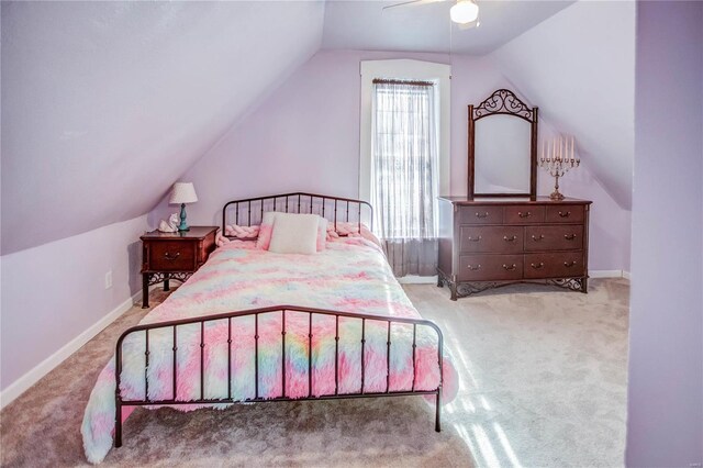 bedroom with ceiling fan, vaulted ceiling, and light carpet