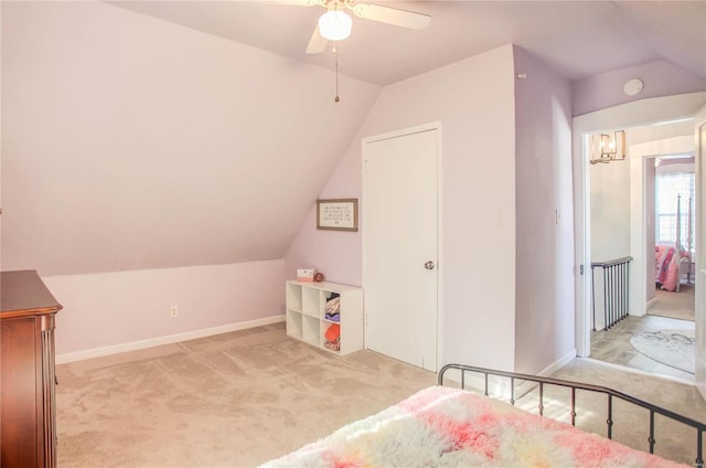 carpeted bedroom featuring lofted ceiling and ceiling fan