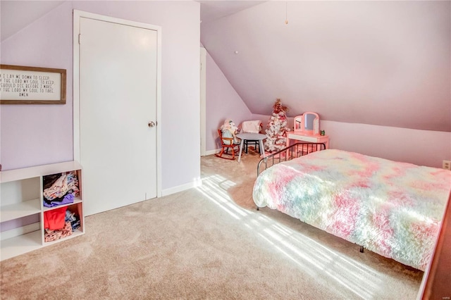 bedroom with carpet floors and lofted ceiling