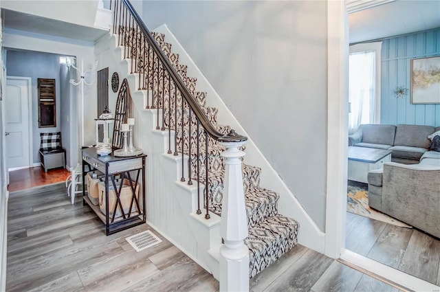 stairs with hardwood / wood-style flooring