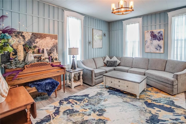 living room featuring a notable chandelier and light hardwood / wood-style floors